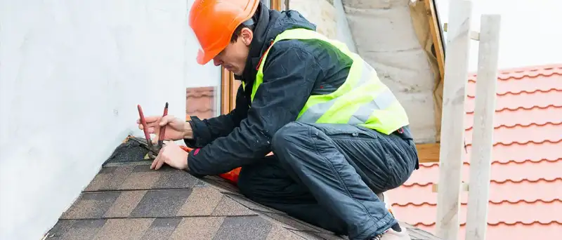 A certified T. Simpson Roofing installer at work